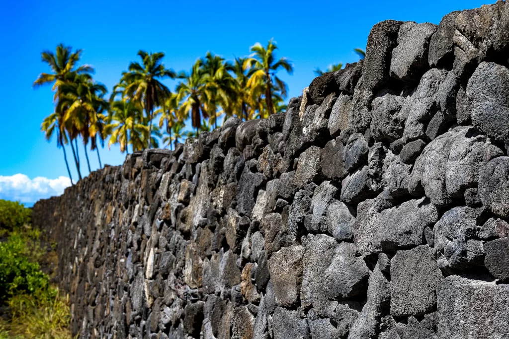 A nineteen foot high basalt rock wall in Puʻuhonua o Hōnaunau National Historical Park.