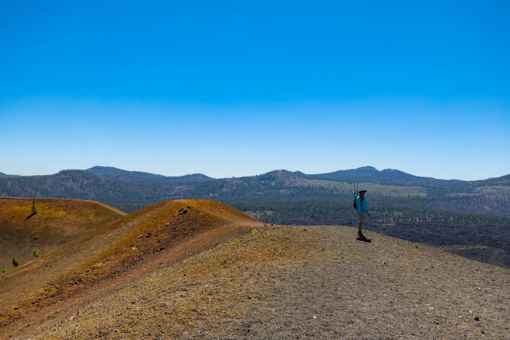 Tom stands on the outer rim of the orange and grey cinder cone.