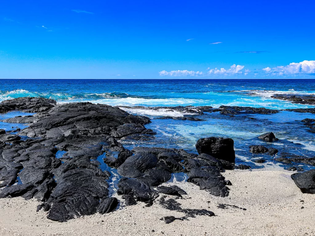 Black lava stretching into the Pacific Ocean on the Big Island of Hawai'i.