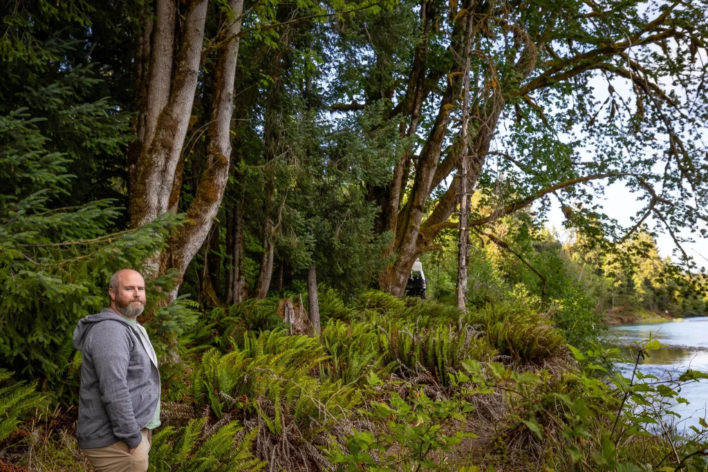 Tom looks at the camera while Ogre peeks from behind a distant tree.