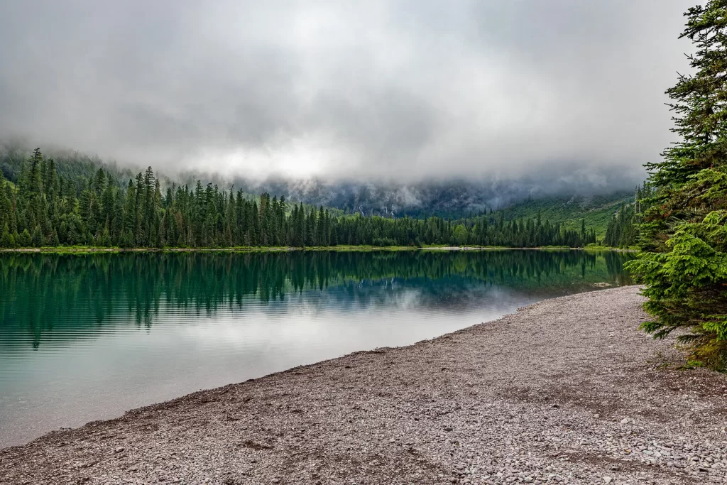 A distant reflection on Avalanche Lake, Glacier National Park.