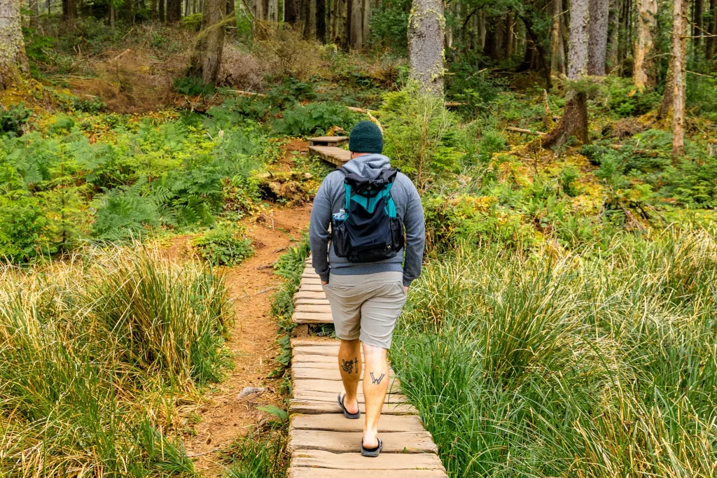 Tom walking on the boardwalk of Cape Flattery Trail.