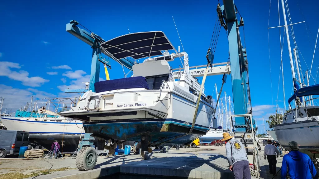 Motor yacht sitting above the water in Travelift slings.