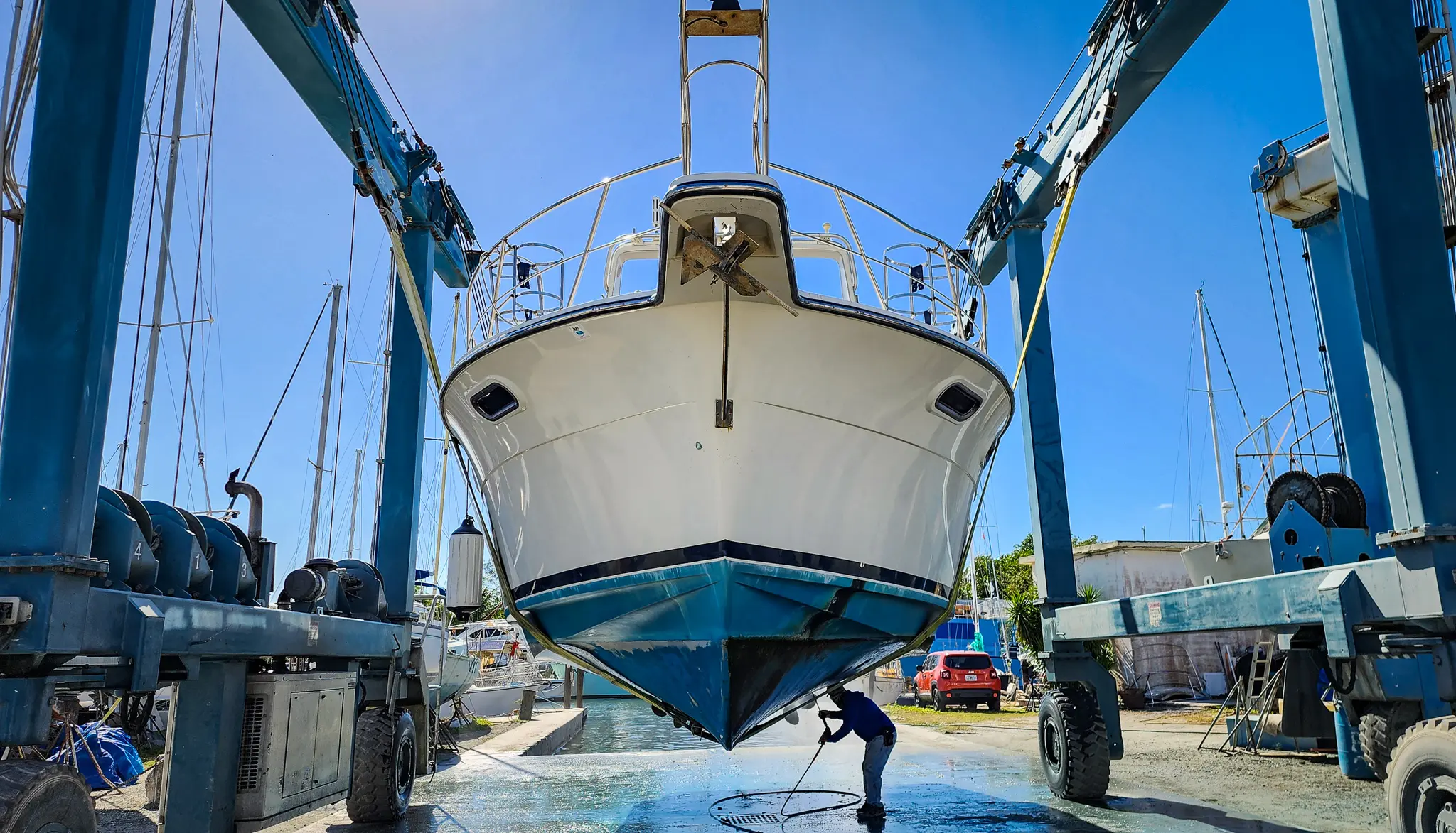 1989 Carver Santego 3867 sitting in slings while being power washed.