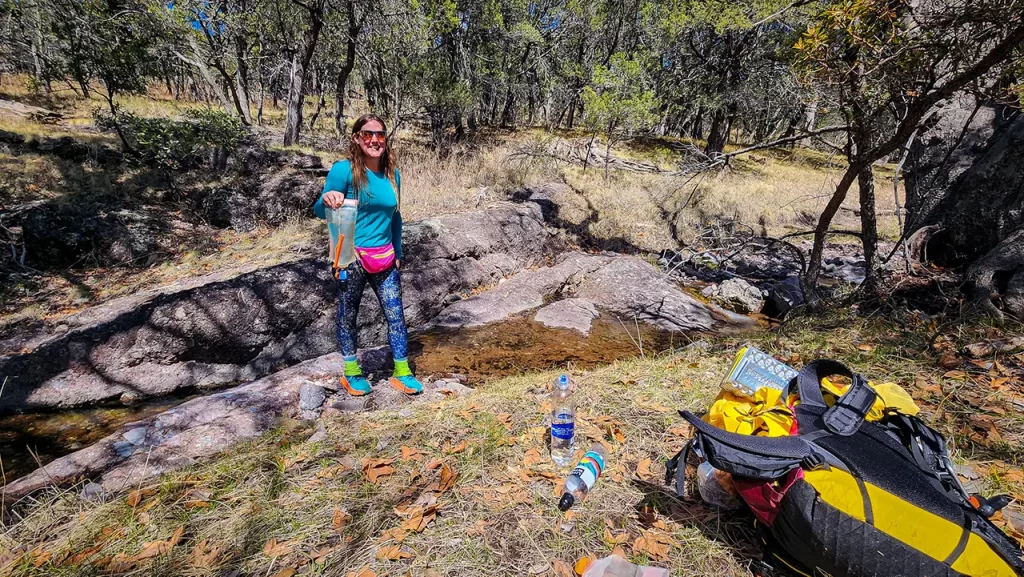 Elyse gathering water from a creek along the Arizona Trail.