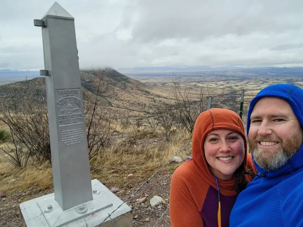 Elyse and Tom pose in front of the Southern Terminus of the Arizona Trail.