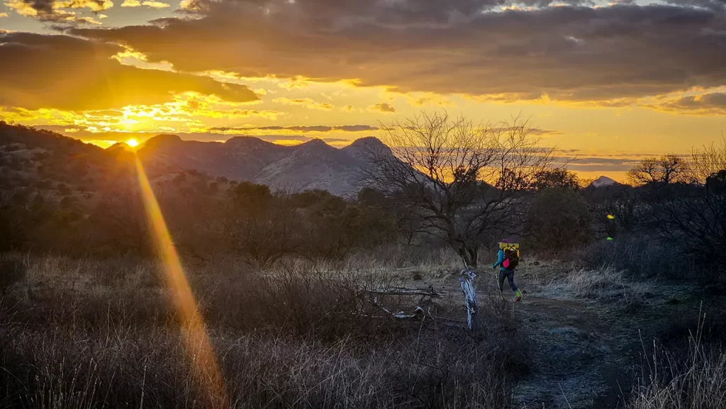 Sunset on the Arizona Trail, Elyse hiking in the distance.