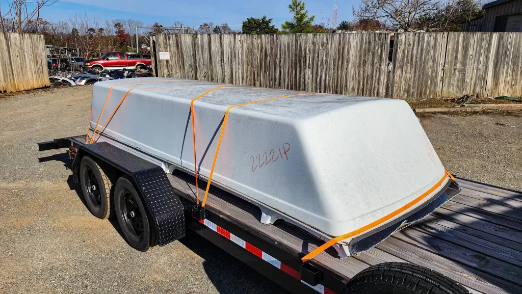 The junk yard van high top on the flatbed trailer on it's way to us!