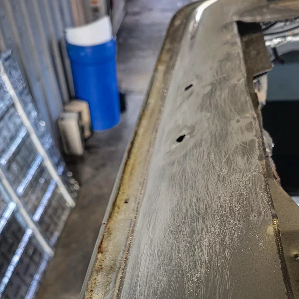 Scuffed paint along the rim of our cut-up van roof.