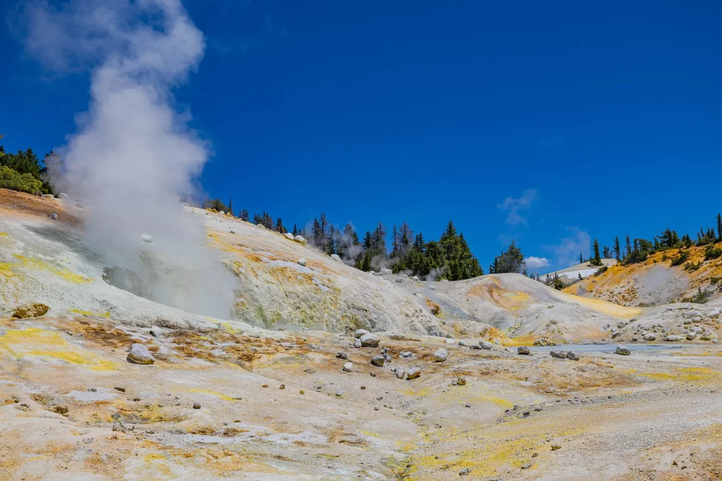 A steaming plume of white rises from a fumarole at Lassen Volcanic National Park.