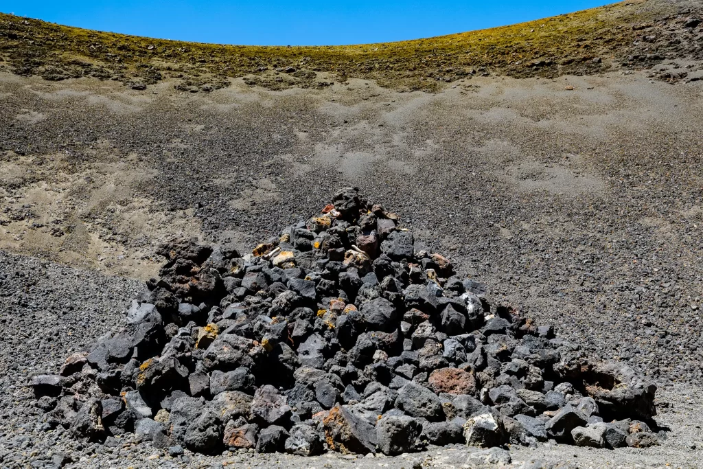 A tall pile of lava rocks at the center of the cinder cone.