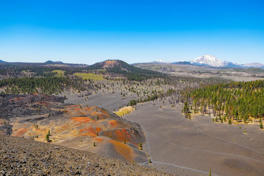 Dunes colored orange and red with Lassen Peak rising in the distance.