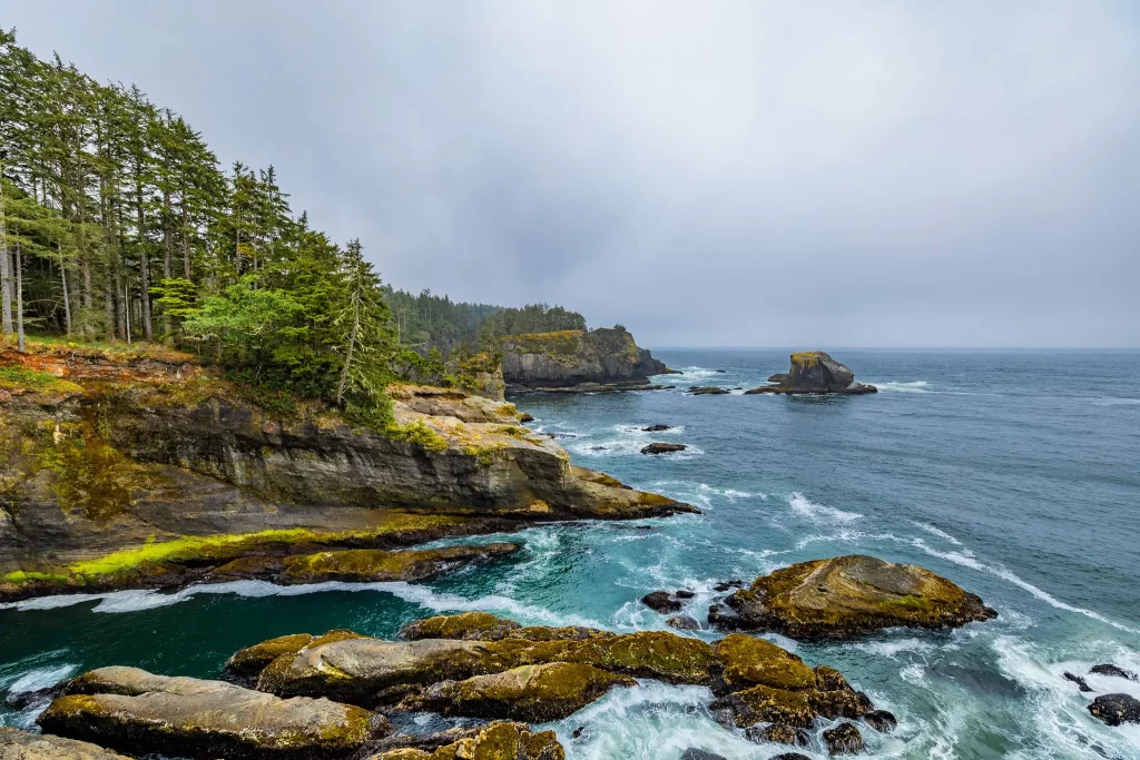 Blue-green waters surround the rocky shoreline of Cape Flattery.