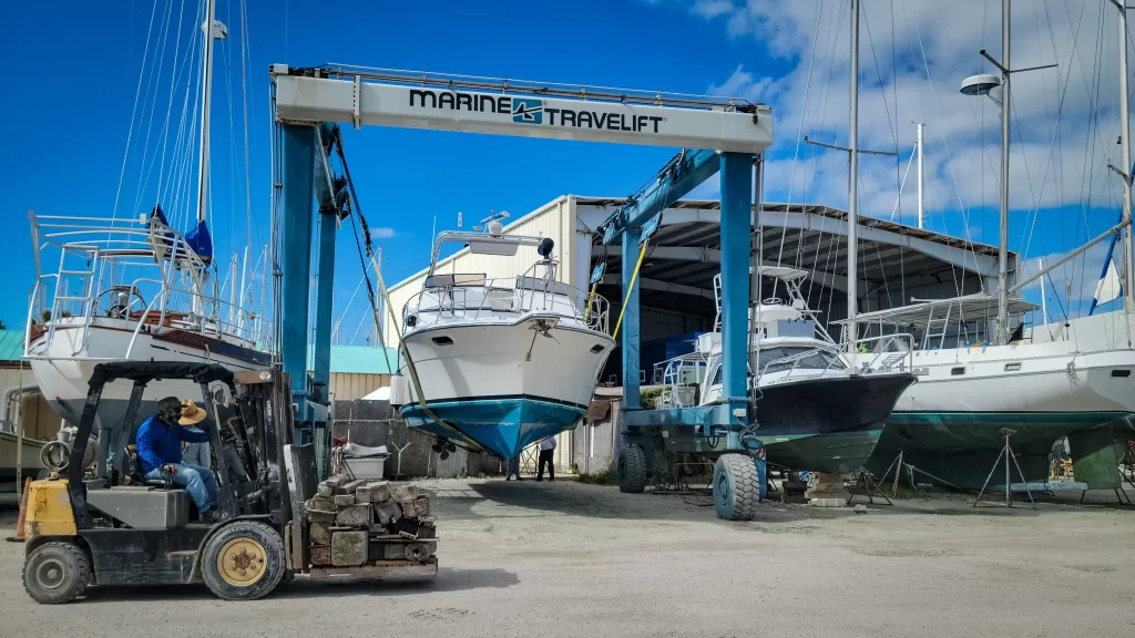 A Marine Travelift hold a 45 foot yacht in the air.