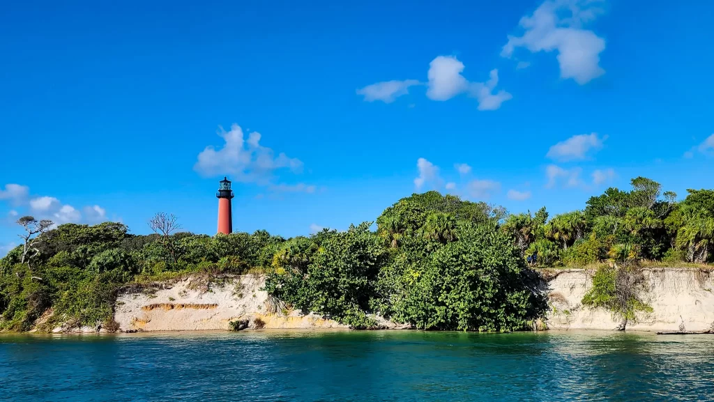 A red lighthouse emerges over the dunes along the ICW.