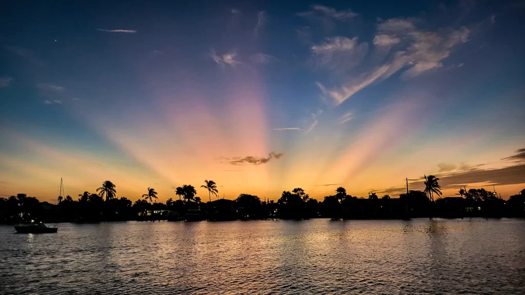 Rays of sunset become colored as the sun sets over Faber Cove.