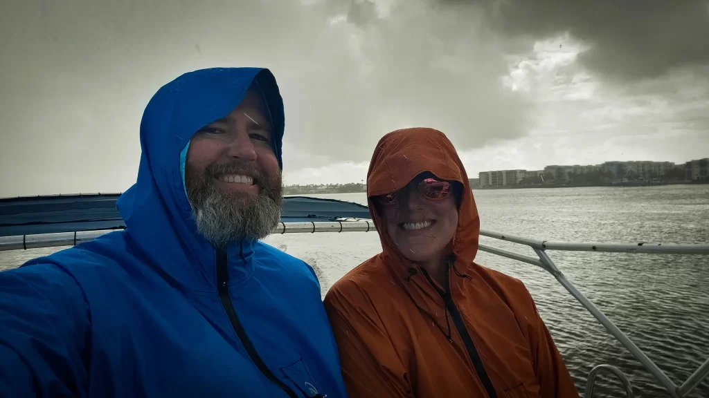 Tom and Elyse in their rain jackets, cruising through a rainstorm.