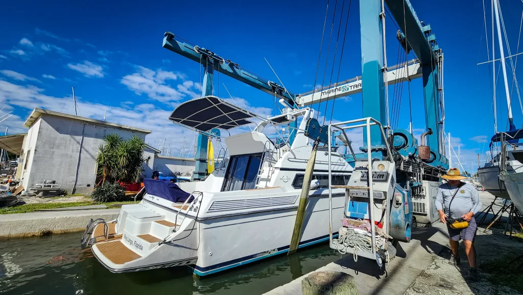 Carver Yacht sits in the Travelift slings prepared to be hauled out of the water.