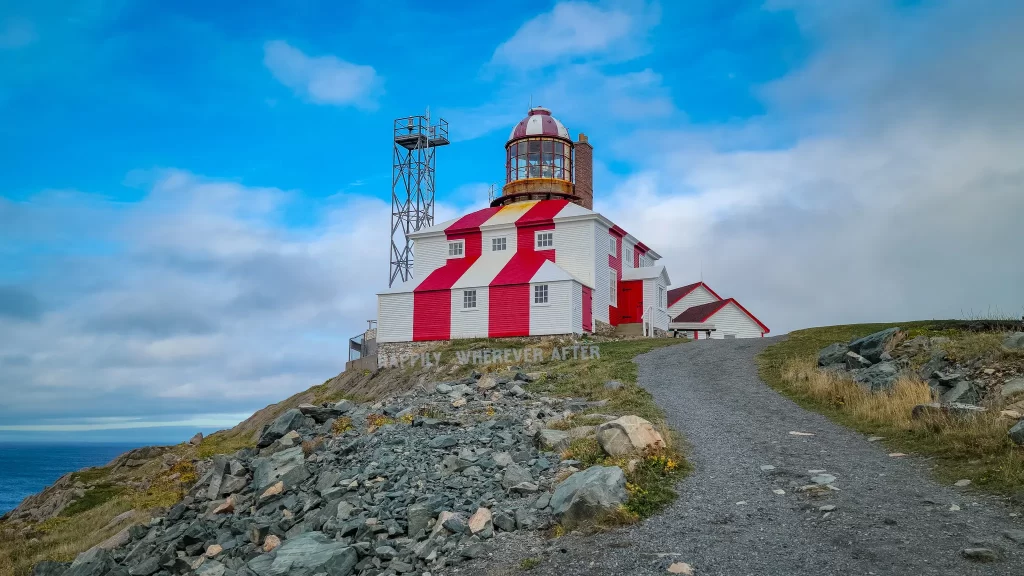 Vivid red and white Cape Bonavista Lighthouse near the puffins in Newfoundland.