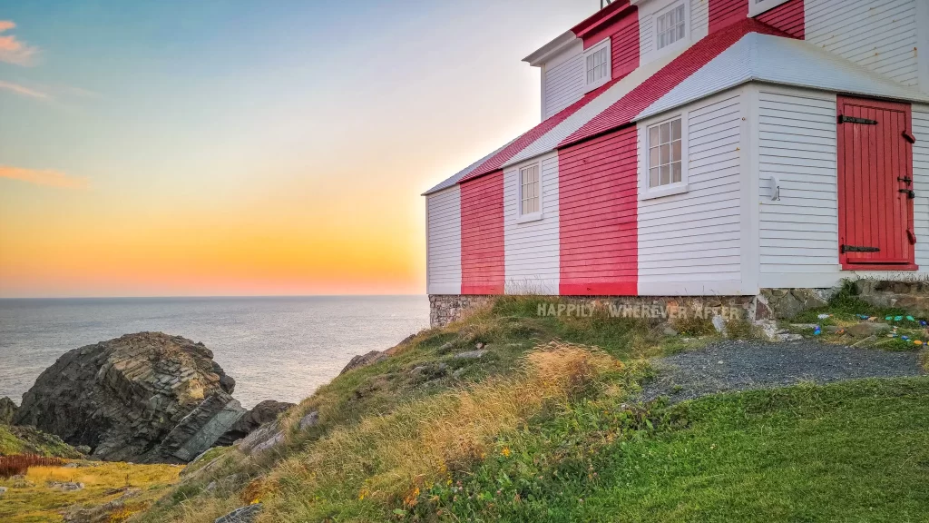 Red and white Cape Bonavista Lighthouse at sunset near the puffin viewing site in Newfoundland.